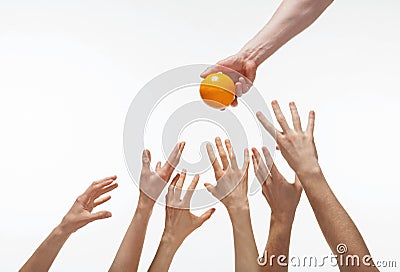 Many hands want to get orange Stock Photo