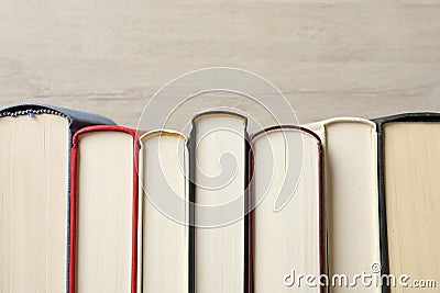 Many hardcover books on wooden background, space for text Stock Photo
