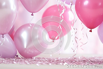 many heart heart foil balloons surrounding pink confetti Stock Photo