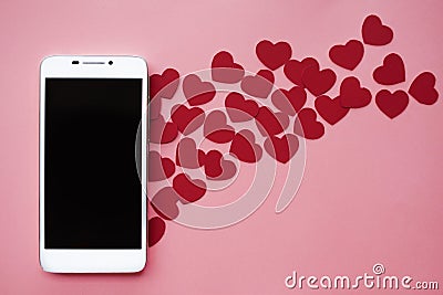 Many hearts and smartphone. Concept to like in social networks or Dating app. pink background Stock Photo