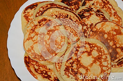 Many homemade pancakes on a white plate Stock Photo