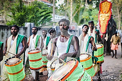 Many indian drummers play national drums walking by indian village on annual festival Editorial Stock Photo