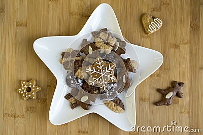 Many kinds of Christmas cookies on white plate, gingerbread dark and light, star shape dish Stock Photo