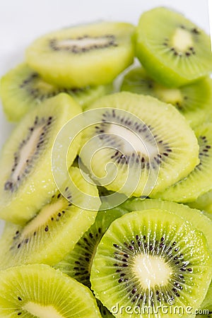 Many kiwi slices are placed in a glass crisper. Kiwifruit slices without peel Stock Photo