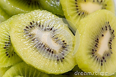 Many kiwi slices are placed in a glass crisper. Kiwifruit slices without peel Stock Photo