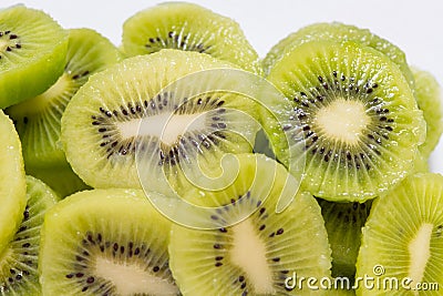 Many kiwi slices are placed in a glass crisper. Kiwifruit slices without peel Stock Photo