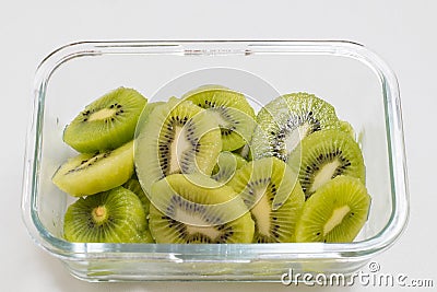 Many kiwi slices are placed in a glass crisper. Kiwifruit slices without peel Stock Photo