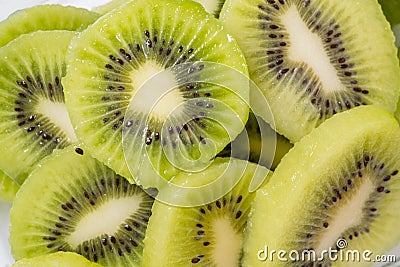 Many kiwi slices are placed in a glass crisper. Kiwifruit slices without peel Stock Photo