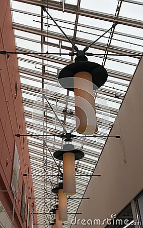 Many lamps hang on the ceiling of the mall. Interior. Electricity. Stock Photo