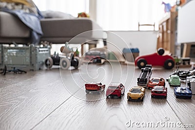 Many metal toy card on an indoor home hardwood floor Stock Photo