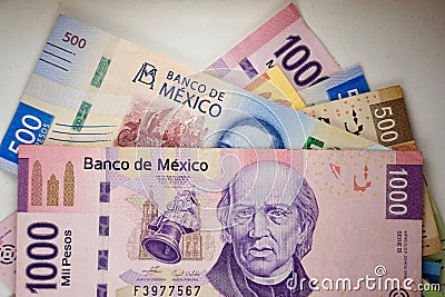Mexican pesos bills spread randomly over a flat surface Stock Photo