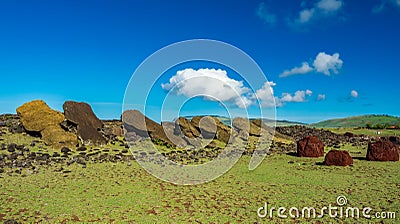 Many moai statues and pukao on the ground Stock Photo