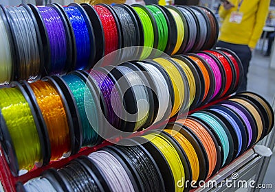 Many multi-colored spools coils of thread of filament for printing 3d printer. Stock Photo