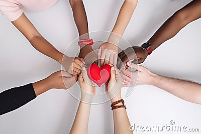 many multiracial hands holding a red heart, unity, love, Generative AI Stock Photo