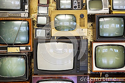 Many old televisions bundled together. A wall of old vintage tube televisions Stock Photo