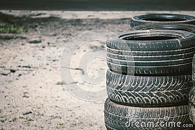 Many old used car tires stacked on top of each other on Automobile sports complex. Industrial landfill for the Stock Photo