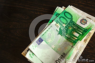 Many one hundred Euro bills resting on table Stock Photo