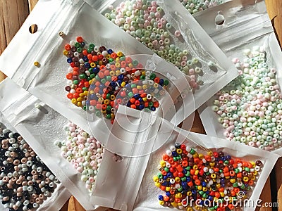 Many packs colorful seed beads, various tiny beads for making necklace and bracelet, creativity, and education. Stock Photo