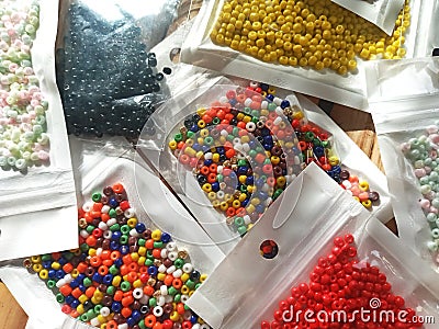 Many packs colorful seed beads, various tiny beads for making necklace and bracelet, creativity, and education. Stock Photo