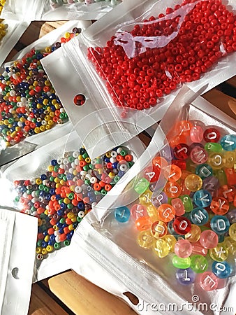 Many packs colorful seed beads, various tiny beads for making necklace and bracelet, creativity, and education. Stock Photo