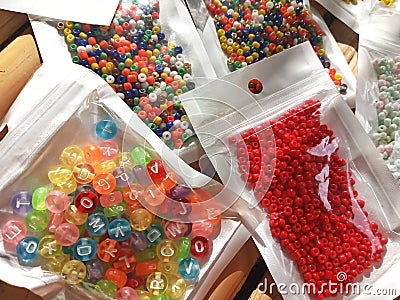 Many packs colorful seed beads, various tiny beads for making necklace and bracelet, creativity, and education. Stock Photo