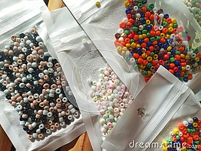 Many packs colorful seed beads, various tiny beads for making necklace and bracelet, creativity, and education. Stock Photo