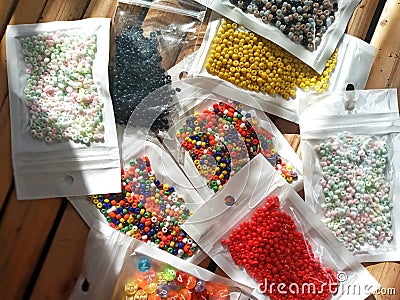 Many packs colorful seed beads, various tiny beads for making necklace and bracelet, creativity, and education. Stock Photo