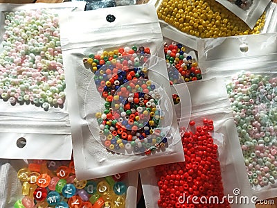Many packs colorful seed beads, various tiny beads for making necklace and bracelet, creativity, and education. Stock Photo