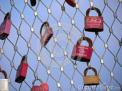 Many padlocks of lovers hanging on bridge railings Editorial Stock Photo