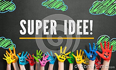 Many painted children hands with smileys and the message `Super Idea ` in German Stock Photo