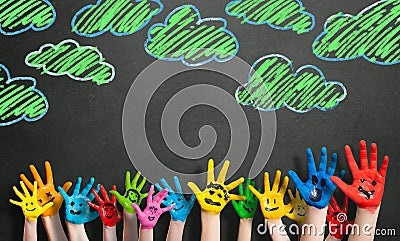 Many painted kids hands with smileys Stock Photo
