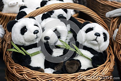 Many panda soft toys in a wicker basket. Stock Photo