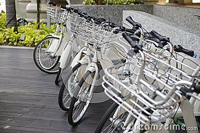 Many parked rental bicycles outdoors Stock Photo