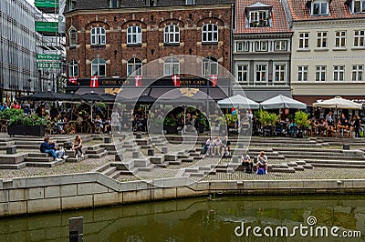 Many people enjoying a sunny day at Aboulevard, the promenade along the river Aarhus A. Aarhus is the second largest city in Editorial Stock Photo