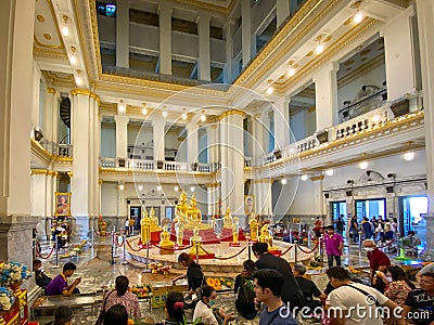 Many people pray respect Golden Buddha statue inside Editorial Stock Photo