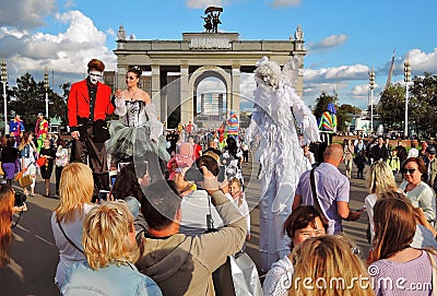 Many people take pictures of street actors in Moscow Editorial Stock Photo