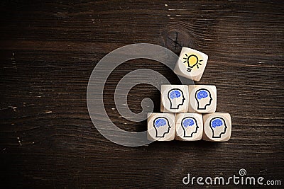 Many people together having an idea symbolized by icons on cubes Stock Photo