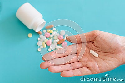 Many pills are poured from a medicine bottle Stock Photo