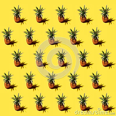 Many pineapples on a solid yellow background pattern Stock Photo