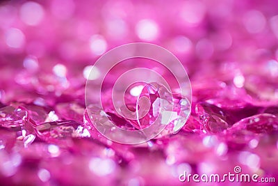 Many pink little crystal hearts with bokeh background. Stock Photo