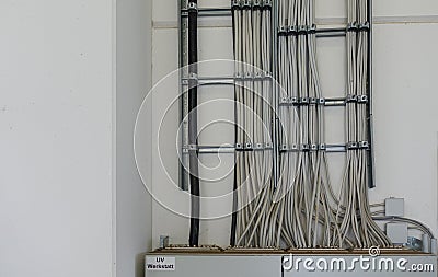 Many power cables lead to a fuse box Stock Photo