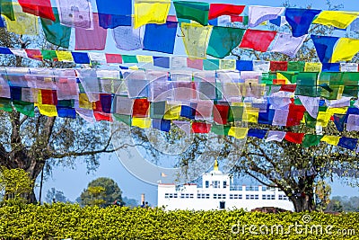 Many prayer flags in the wind against the Holy Maya Devi Temple in Lumbini, Nepal Stock Photo