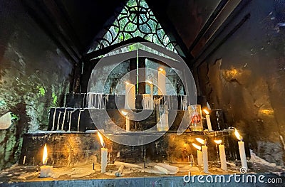 Many prayers candle flames glowing in the dark create a spiritual atmosphere Stock Photo