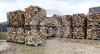 Many Prepared container firewood storage outside package store Stock Photo