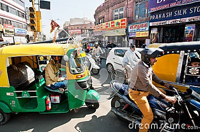 Many private yellow-green rickshaw cabs and cars Editorial Stock Photo