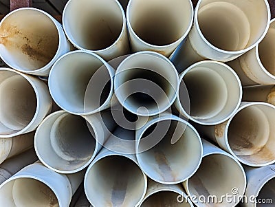 Many PVA Pipes Stacked in Building Supply Warehouse Stock Photo