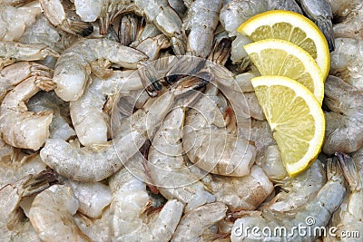 Many Raw Green King Size Shrimps With Lemon Slices Stock Photo