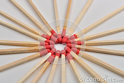 Many red head matches placed in a circle, head to headon white b Stock Photo
