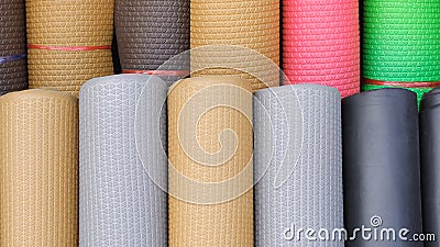 Many rolls of various colors multi-purpose rubber sheet flooring background Stock Photo