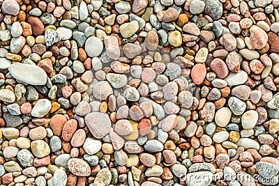 Many round and smooth colorful pebbles seen from above. Stock Photo